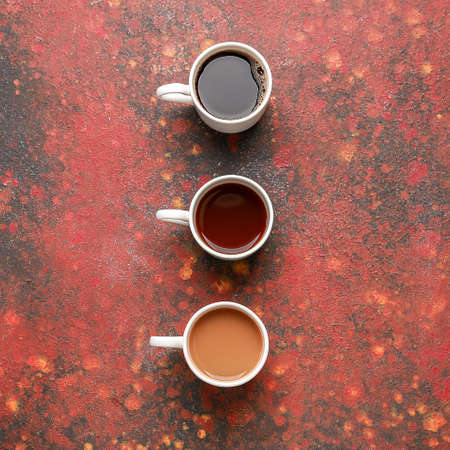 Cups of different coffee on color backgroundの写真素材