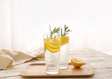 Glasses of cold lemonade on white tableの写真素材