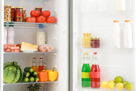 Different products on shelves in fridgeの写真素材