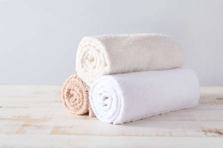 Soft clean towels on wooden tableの写真素材
