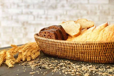Basket with assortment of fresh bread on table