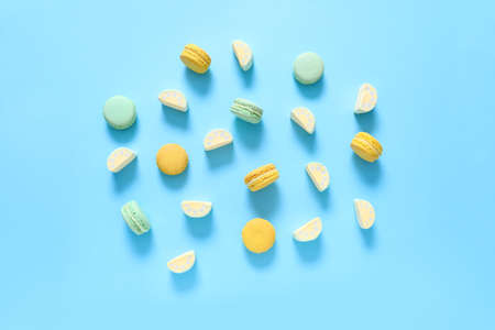 Tasty macarons with marshmallows on color background