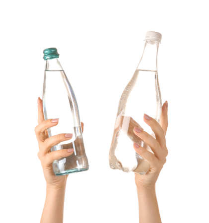 Female hands with bottles of water on white backgroundの写真素材