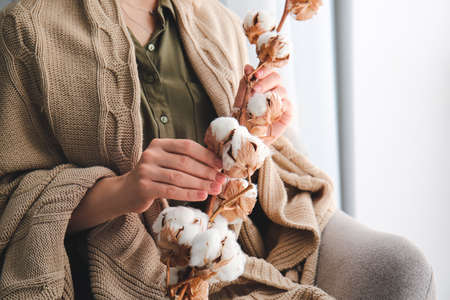Woman with beautiful cotton flowers, closeupの写真素材