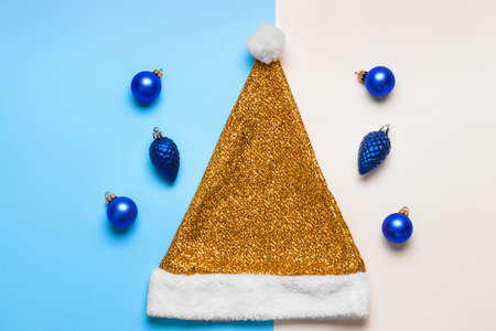 Santa Claus hat with Christmas decor on color backgroundの写真素材
