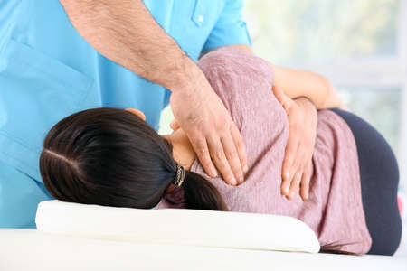 Physiotherapist working with female patient in rehabilitation center, closeupの写真素材