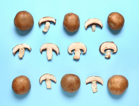 Fresh champignon mushrooms on color backgroundの写真素材