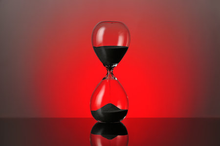 Crystal hourglass on color backgroundの写真素材