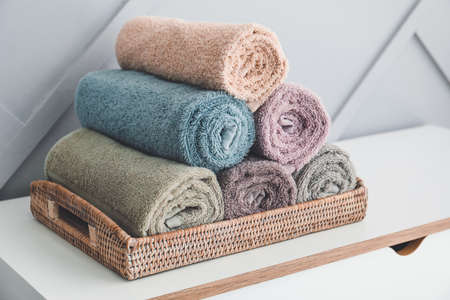 Clean towels on table near light wallの写真素材