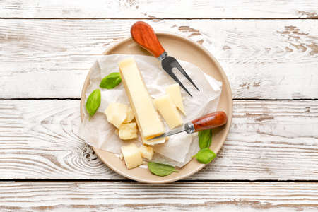 Plate with tasty Parmesan cheese on tableの写真素材