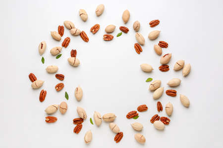 Frame made of tasty pecan nuts on white backgroundの写真素材