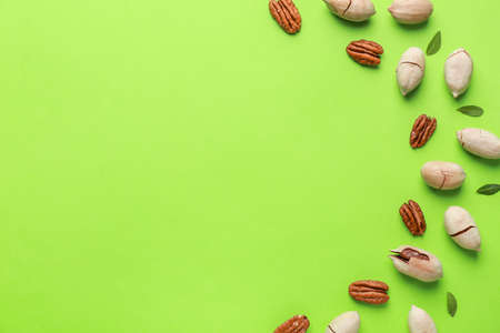 Tasty pecan nuts on color background