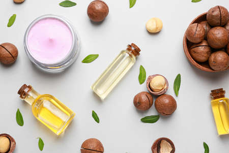 Macadamia nuts with oil and cream on light backgroundの写真素材