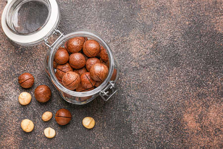 Jar with macadamia nuts on gray backgroundの写真素材