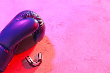 Boxing glove and mouth piece on color backgroundの写真素材