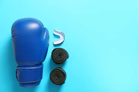 Boxing glove, wrist bands and mouth piece on color backgroundの写真素材