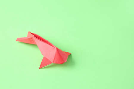 Cute origami fish on color backgroundの写真素材