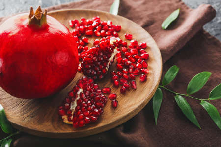 Plate with tasty pomegranate on tableの写真素材