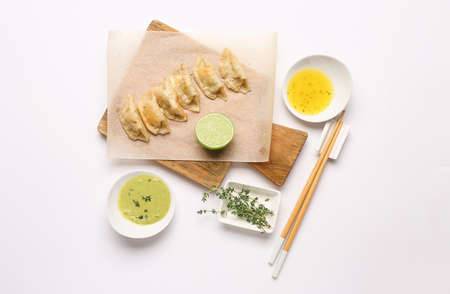 Tasty Japanese gyoza and sauces on white backgroundの写真素材