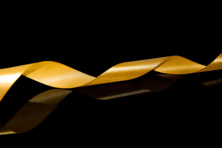 Beautiful golden ribbon on dark backgroundの写真素材