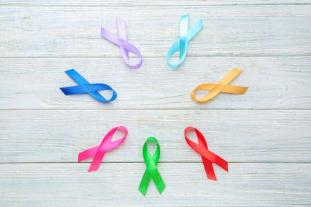 Different awareness ribbons on light wooden backgroundの写真素材
