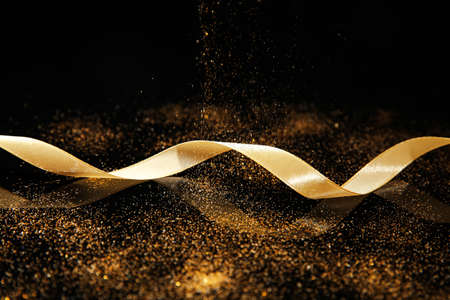 Beautiful golden ribbon on dark backgroundの写真素材
