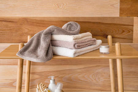 Stack of towels on table in bathroom