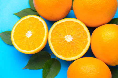 Fresh oranges on color backgroundの写真素材