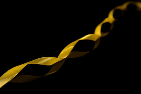 Beautiful golden ribbon on dark backgroundの写真素材