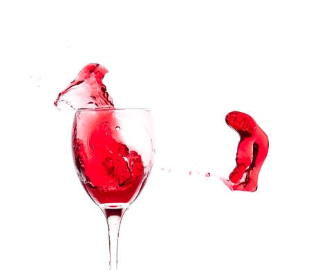 Glass of wine with splash on white backgroundの写真素材
