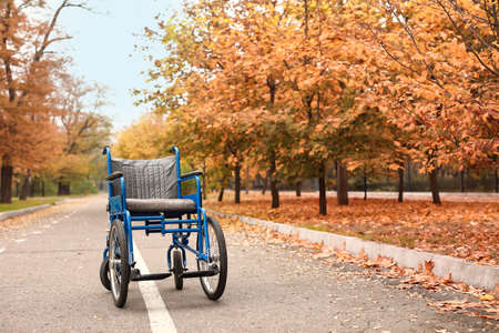 Empty wheelchair in autumn parkの写真素材