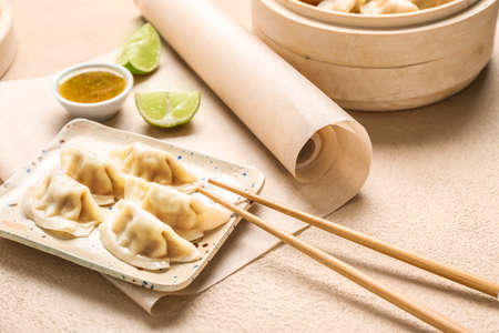 Plate with tasty Japanese gyoza on light backgroundの写真素材