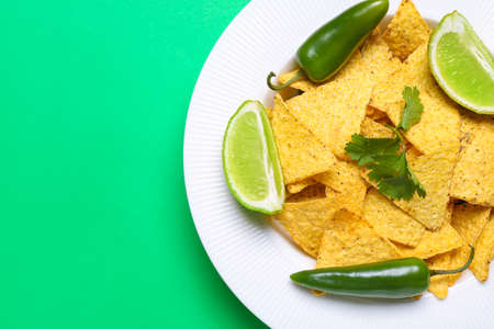 Plate with tasty nachos on color backgroundの写真素材