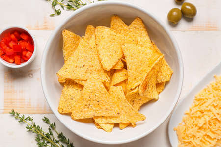 Bowl with tasty nachos on table