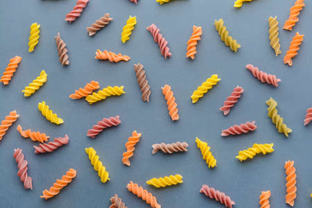 Tasty uncooked pasta on gray backgroundの写真素材