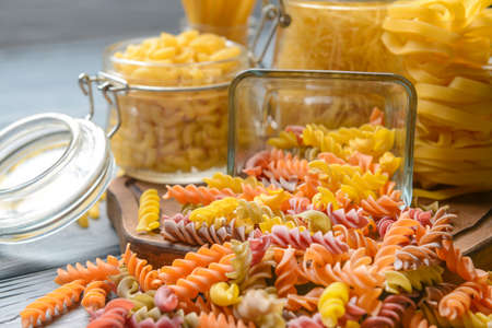 Different uncooked pasta on tableの写真素材