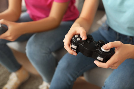 Friends playing video game at home, closeupの写真素材