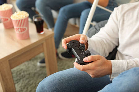 Young man playing video game at home