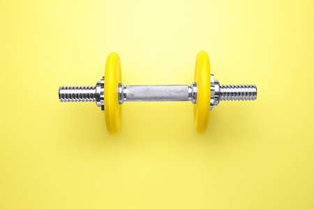 New dumbbell on color background