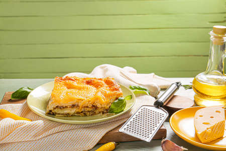 Plate with tasty baked lasagna on table