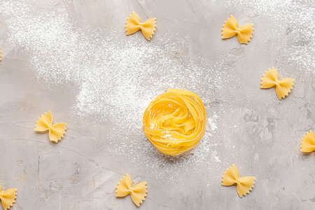 Uncooked pasta on gray backgroundの写真素材