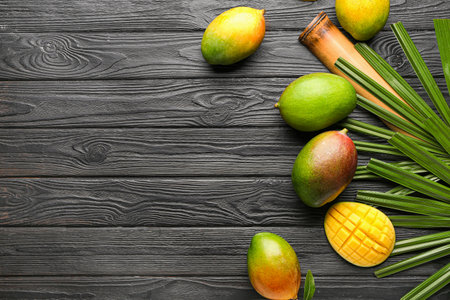 Tasty mango fruit on dark wooden backgroundの写真素材