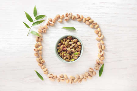 Composition with tasty pistachio nuts on table