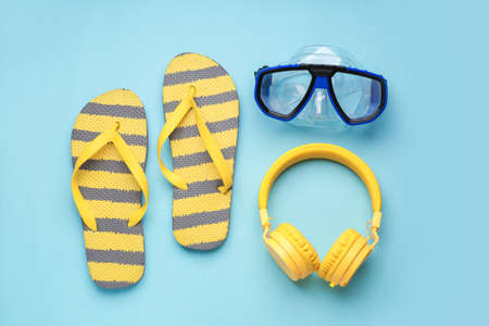 Flip-flops, snorkeling mask and headphones on color backgroundの写真素材