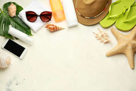 Composition with beach accessories on light background