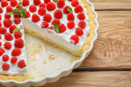 Tasty raspberry pie on wooden background