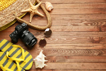 Composition with beach accessories on wooden background