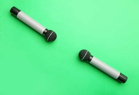 Modern microphones on color backgroundの写真素材
