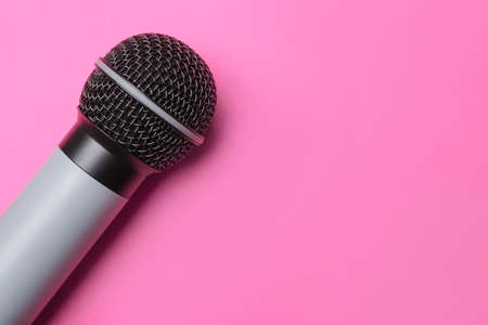 Modern microphone on color backgroundの写真素材