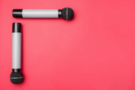 Modern microphones on color backgroundの写真素材